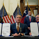 Texas Gov. Greg Abbott, center, signed legislation into law in June to reform the Electric Reliability Council of Texas (ERCOT) and weatherize and improve the reliability of the state’s power grid.